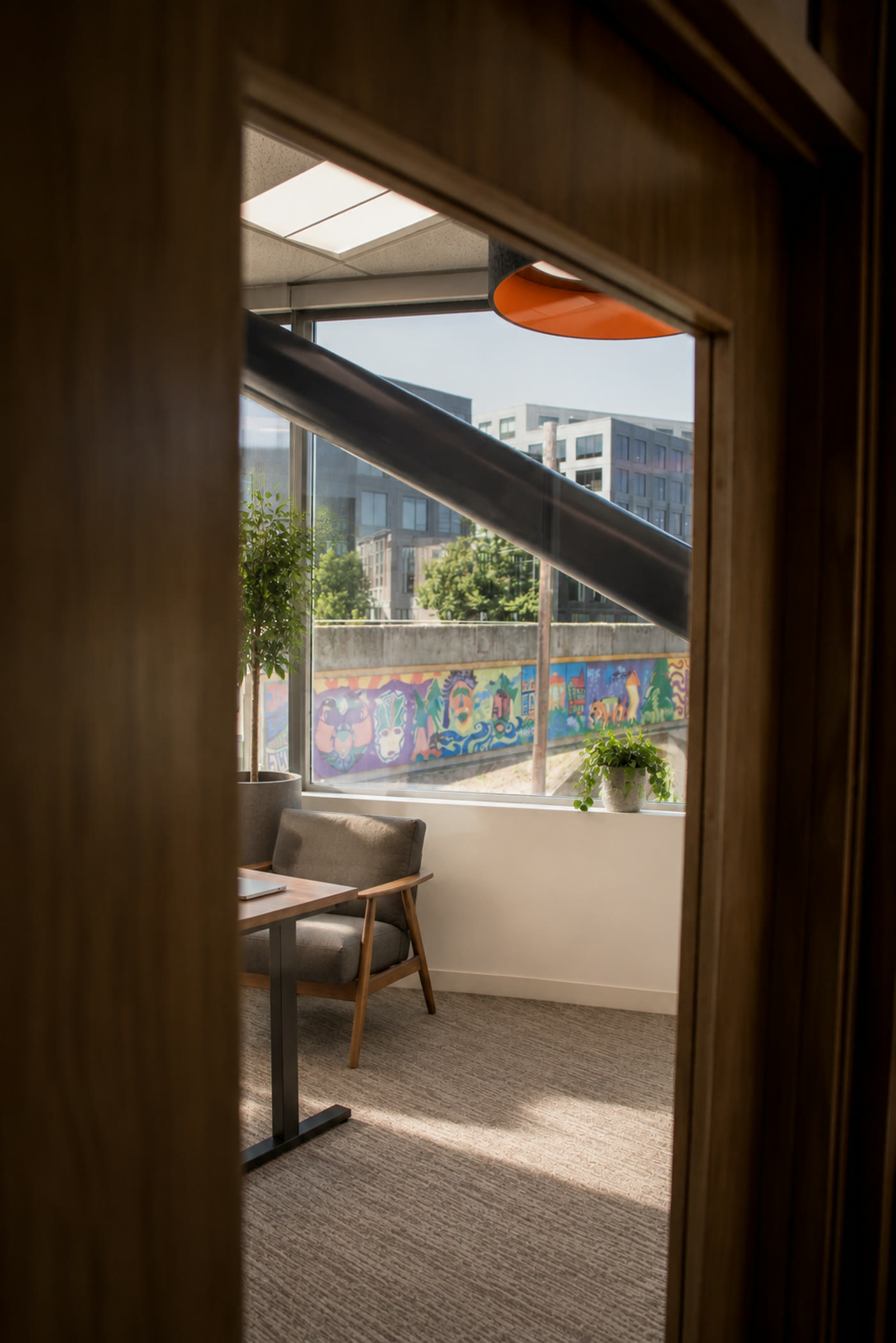View through oak doorway into a private office overlooking the city