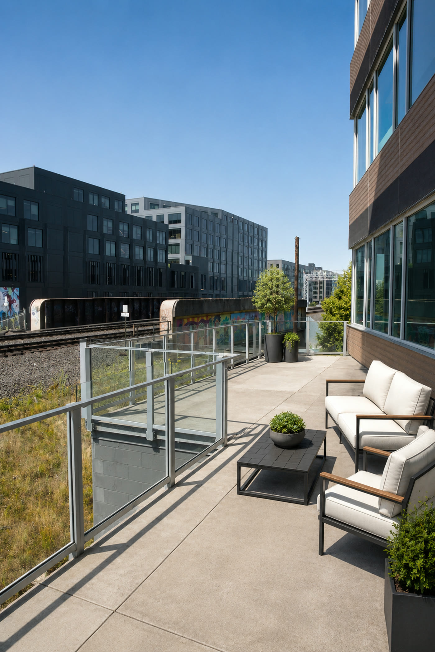Private outdoor terrace with lounge seating and downtown views